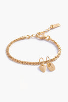 A personalised Lace Chain Bracelet featuring a heart charm and soild gold rectangular initial pendant, designed as an elegant fine jewellery gift for all ages.