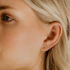 A close up look at the Petite Shell Stud worn with the Petite Vintage Pearl Earring.