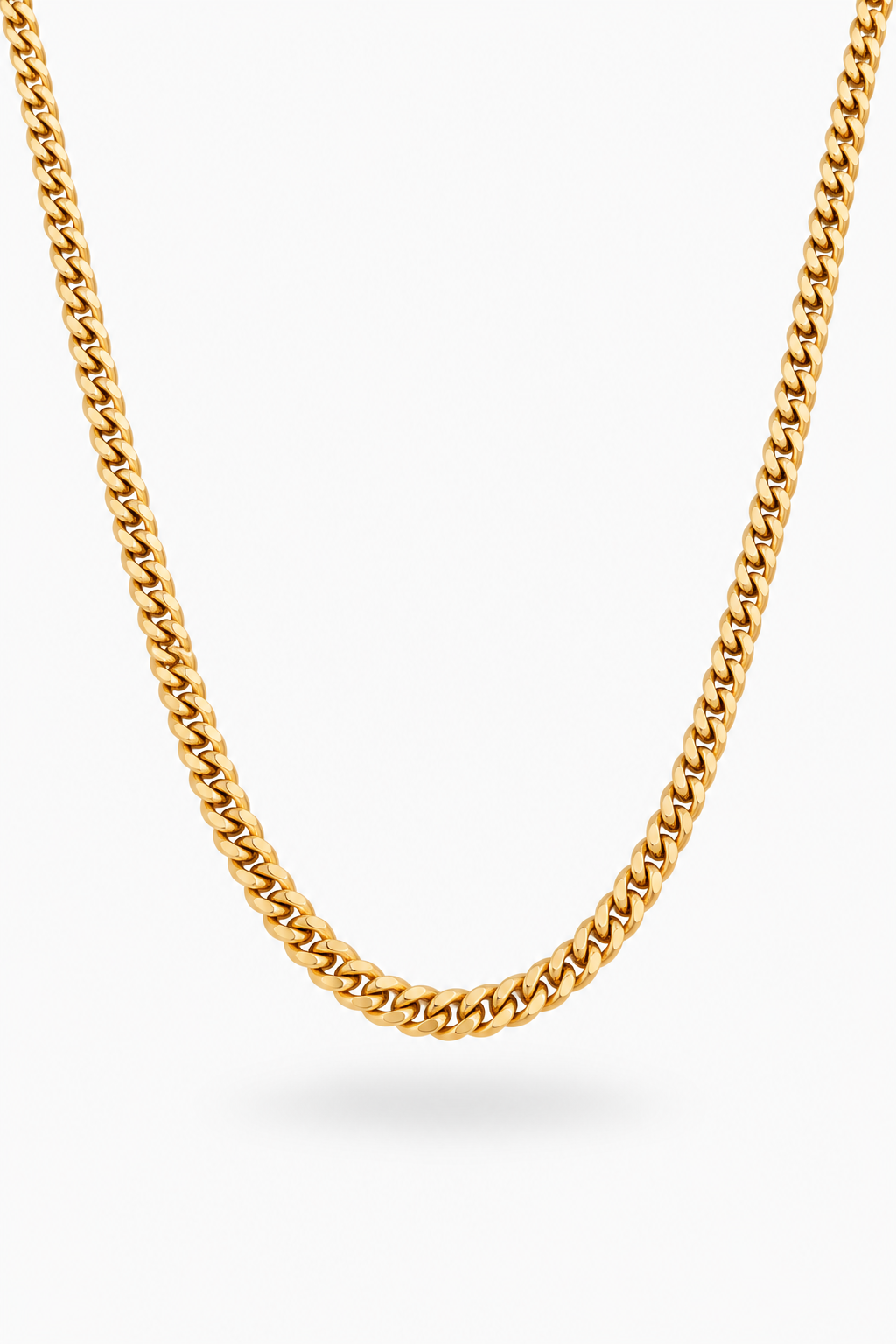 A close-up of a gold-toned curb chain necklace draped in a U-shape against a clean white background.