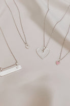 Collection of silver necklaces including Darling Bar with engraved heart and petite heart pendants