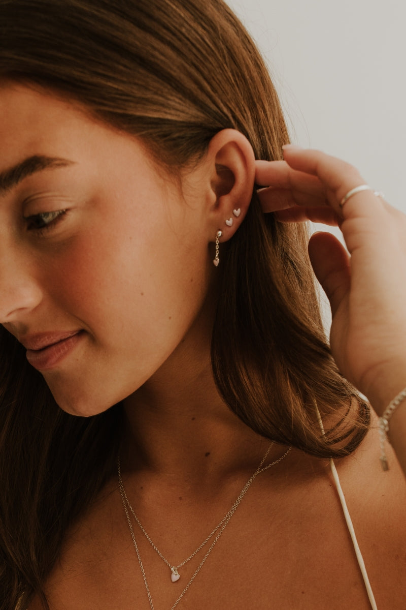Darling Drop Sterling Silver Earrings layered with studs for a soft, everyday personalised look.