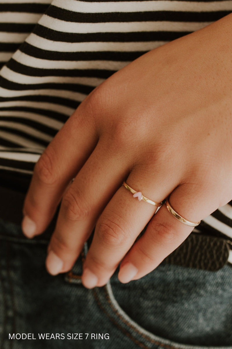Darling Ring Gold with pink engraved heart worn by model with size 7 ring, styled stack