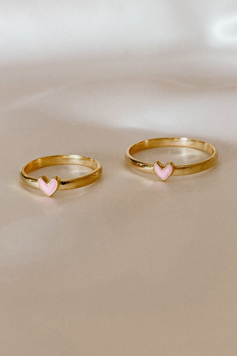 Two Darling Ring Gold pieces side by side, engraved pink heart detail shown in two sizes