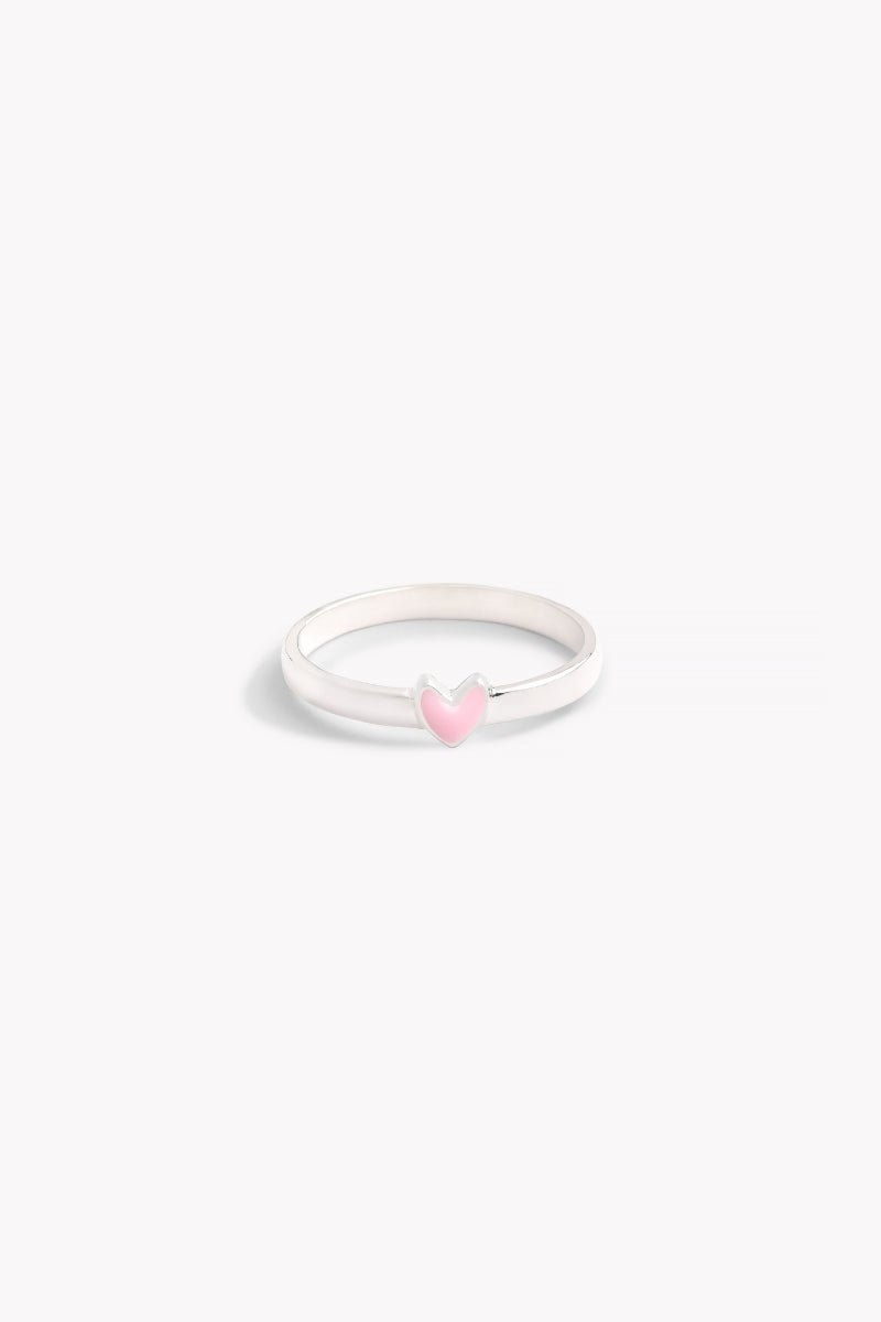 A silver ring with a classic band design and a pink heart-shaped embellishment on the top.