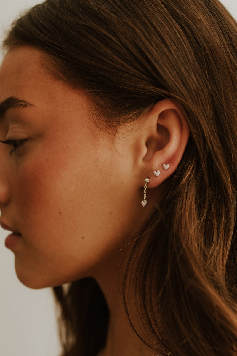 Everyday-friendly Darling Drop Sterling Silver Earrings worn in a stacked style with matching studs.