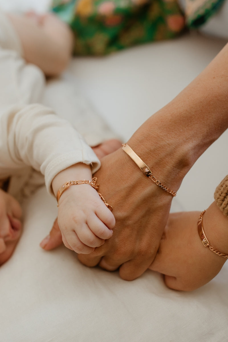 Family wearing matching Pink Darling Rose Gold bracelets—personalised keepsake jewellery for babies, mums, and generations by Bluebird Jewellery.