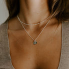 Two Rectangular Initial Pendants are worn on a Fine Curb Chain.