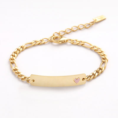 A Pink Darling Bracelet in Gold Vermeil is shown in a close up product image.  The barcelet features a figaro bracelet chain with an ID bar pendant with a small pink heart set on the end of the pendant. 