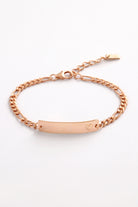 A Pink Darling Rose Gold Bracelet featuring a solid heart detail, shown in a close-up of the engraved ID plate.