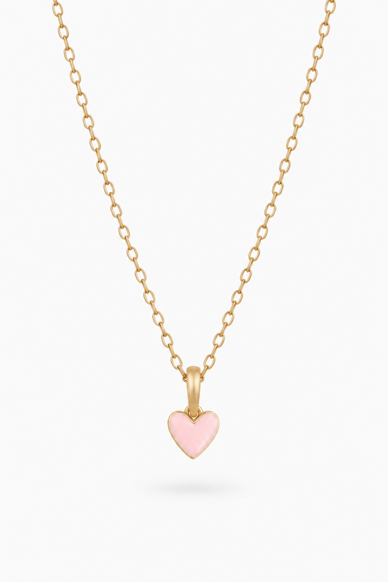 A petite necklace designed for children and adults that features a soft pink heart pendant alongside optional initial pendant/s