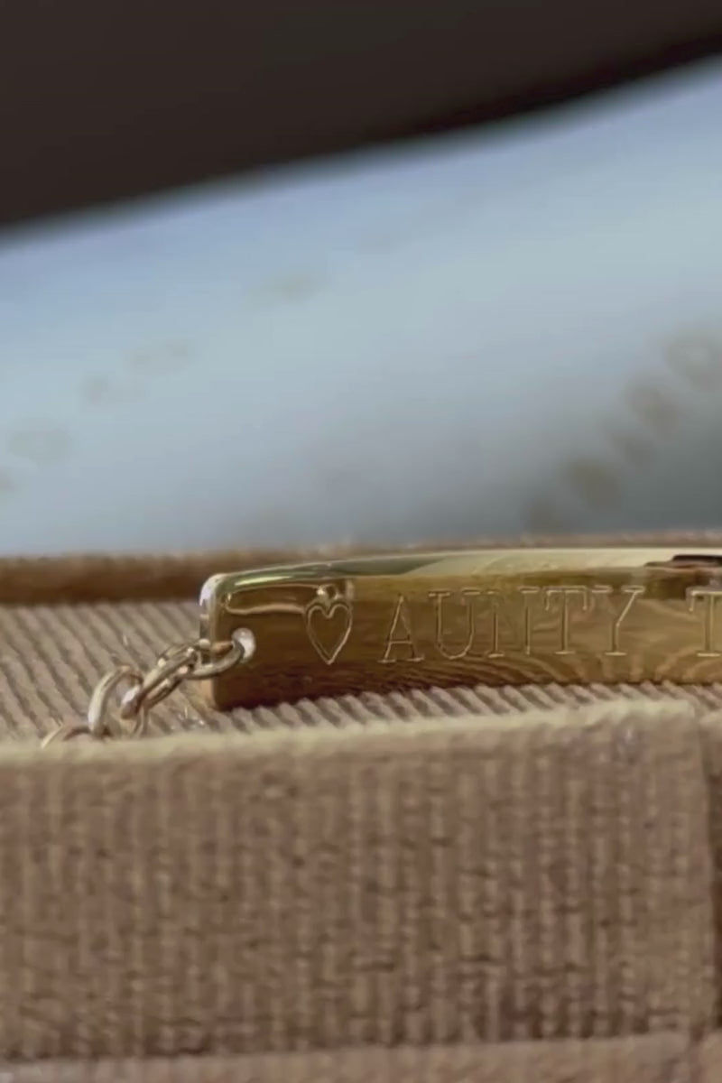 a close up look at the engraving on the rear of a solid gold engravable Pink Darling Bracelet