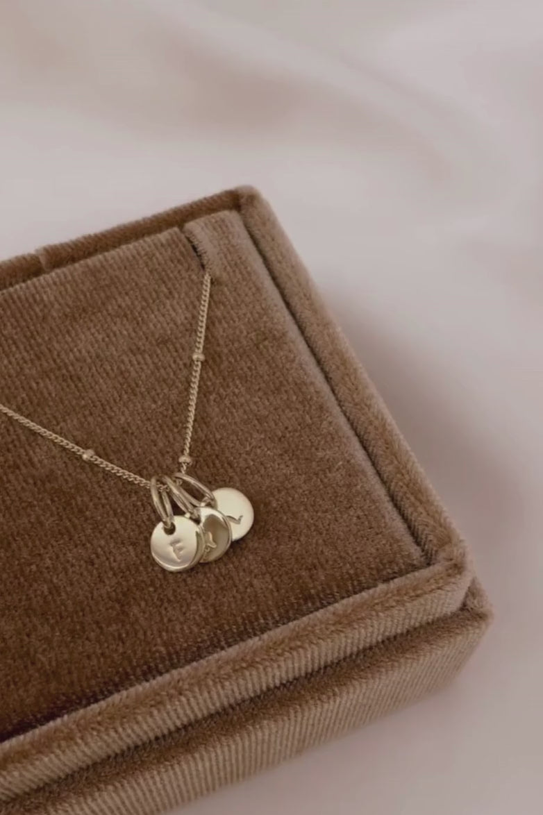 A close up look at a Gold Petite Personalised Necklace with solid 9ct Gold Initial Pendants