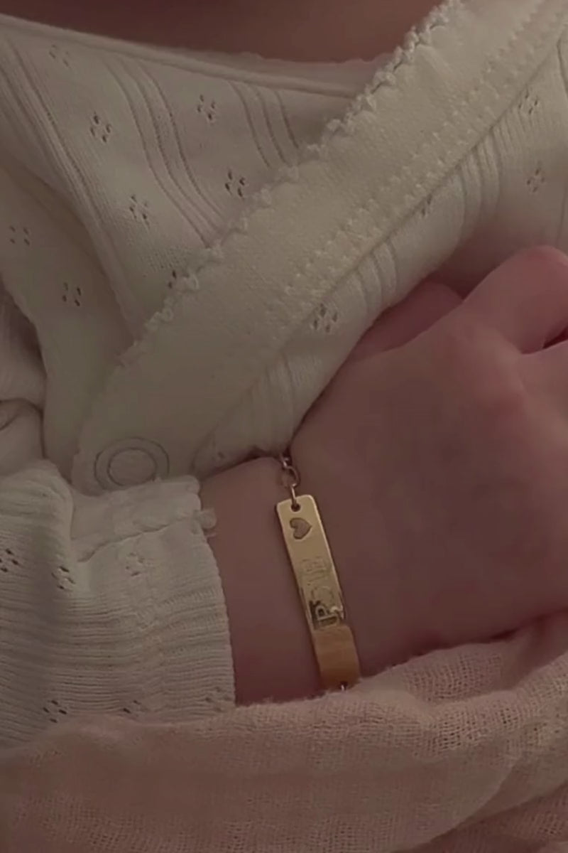 Baby hand wearing engraved 9ct solid gold Pink Darling Bracelet, a forever keepsake