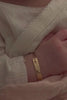 Baby hand wearing engraved 9ct solid gold Pink Darling Bracelet, a forever keepsake