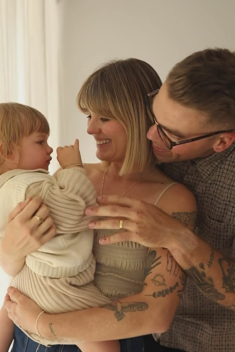 A father is with his wife and child and he is wearing the Solid Gold Signature Men's Ring in the size 10 on his ring finger.  This video captures the connection between the child, woman and man and their bond, like the ring is strong.