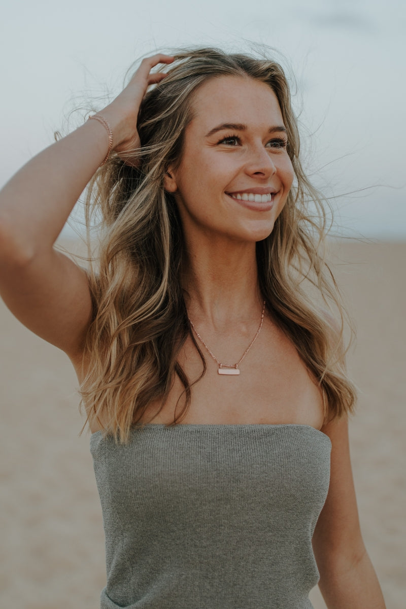 Rose gold Signature Bar Necklace styled on model. Personalised engraved jewellery perfect for everyday wear.