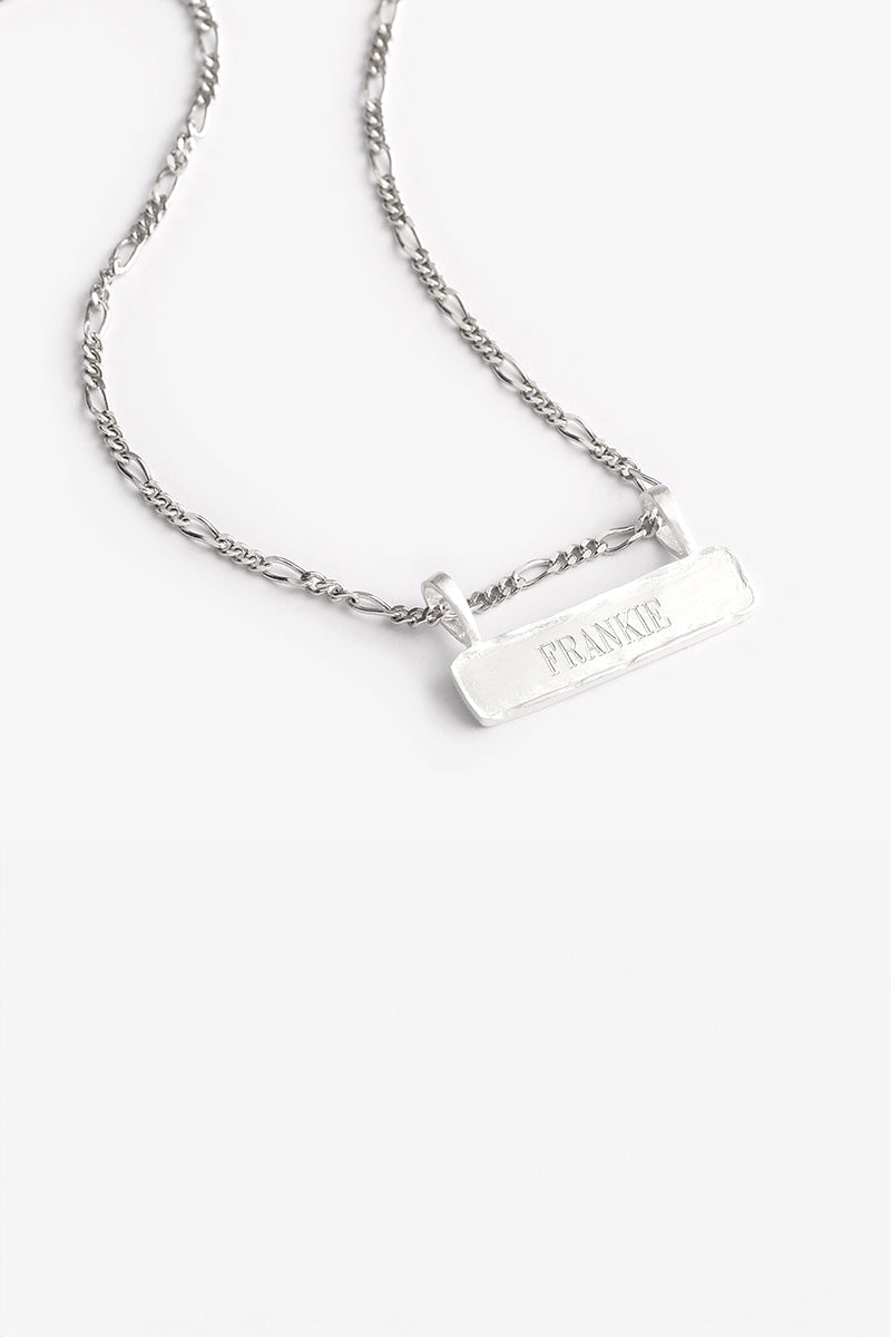 Signature Bar Necklace Silver engraved with “FRANKIE” displayed on a clean white background. A minimal and elegant silver name necklace.