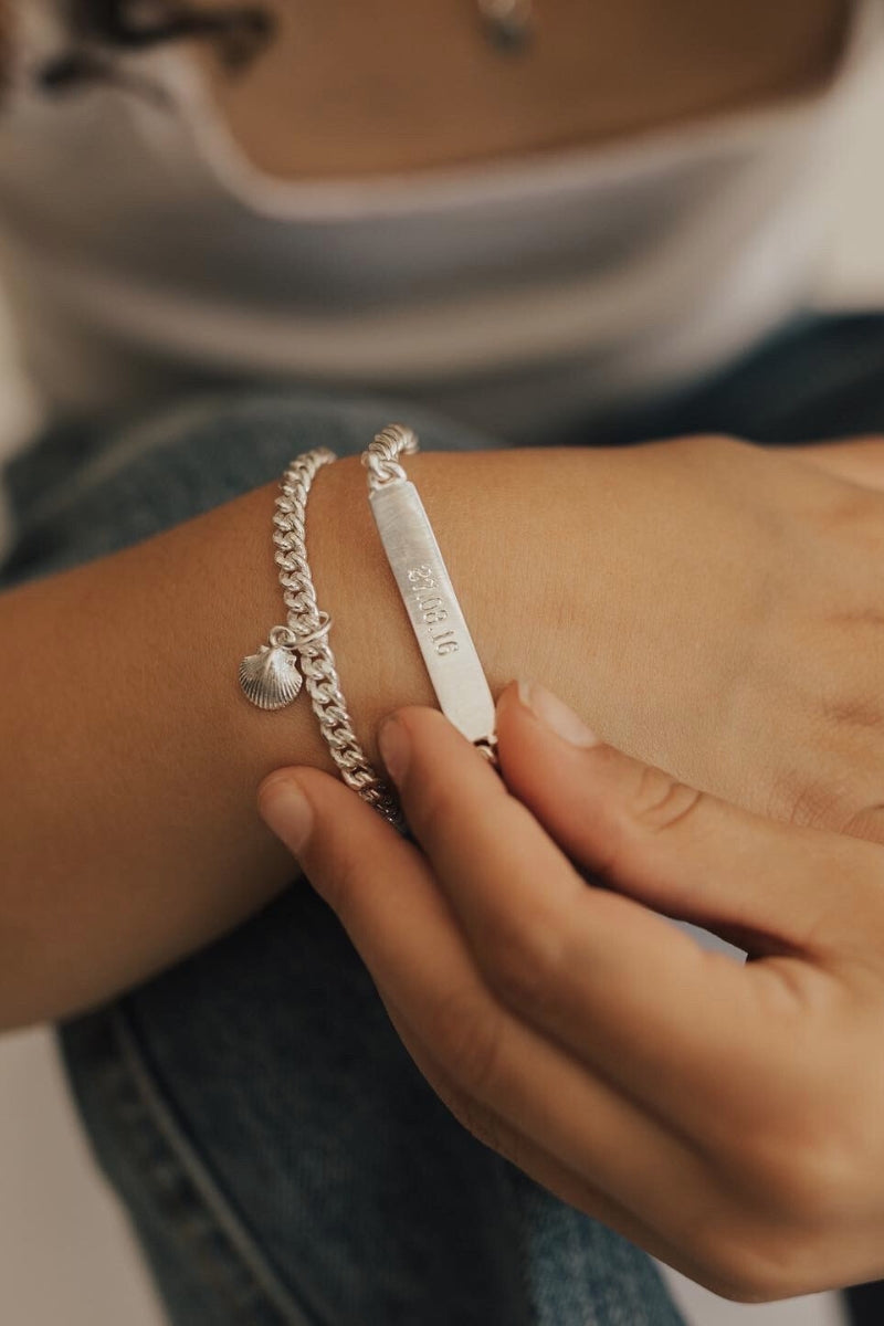 Teen girl wearing engraved bracelet and ring set, styled as everyday jewellery