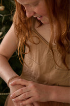 Rose gold signature bracelet worn by a child, designed as a personalised keepsake that grows with them.