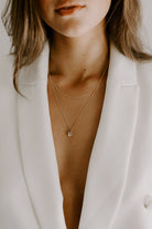 a model wears a 45cm and 55cm solid gold necklaces layered