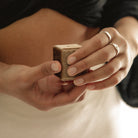 A woman holds a velvet ring gift box.