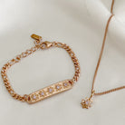 A close-up of the Daisy Bracelet and Daisy Necklace by Bluebird Jewellery, featuring hand-drawn daisy details and pink cubic zirconia accents for a touch of sparkle.