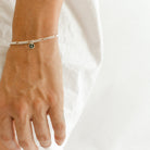 A Figaro Bracelet in adult length worn with one 6mm initial pendant by Bluebird Jewellery
