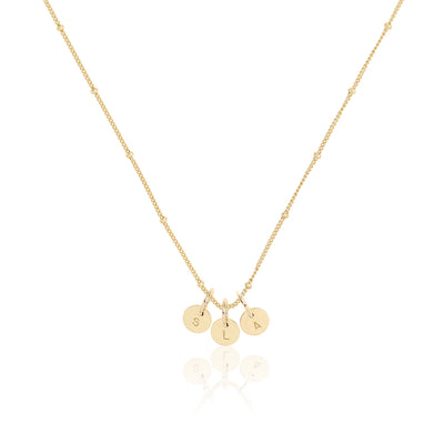 A gold petite personalised necklace with solid 9ct gold initial pendants on a ball chain necklace in gold.