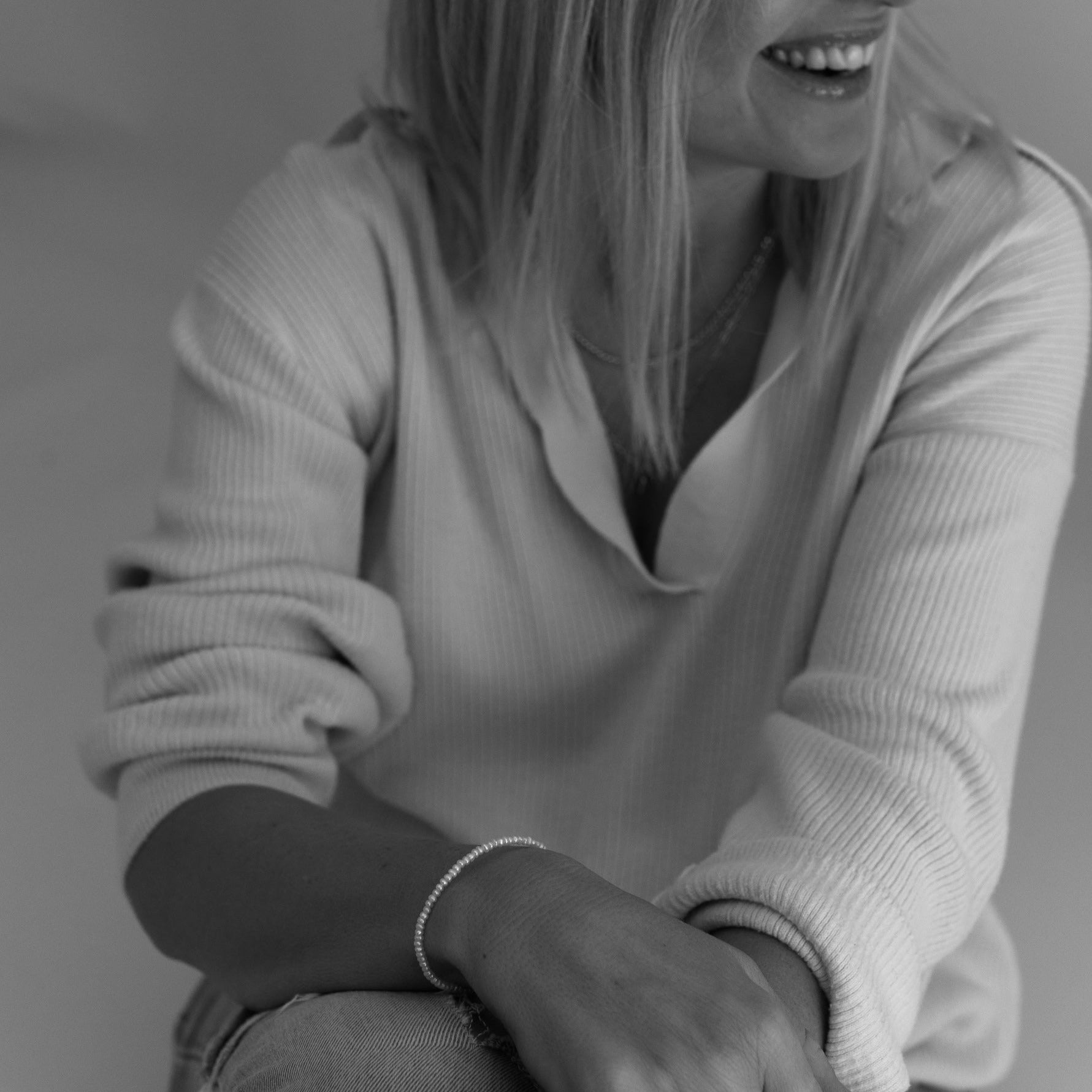 A woman is wearing a Freshwater Pearl bracelet.