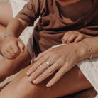 A son is sitting with his mother at the beach and she is wearing a signet ring that sits beautifully on our finger.  She also wears a Single Pearl bracelet and her son is wearing his Classic ID bracelet.