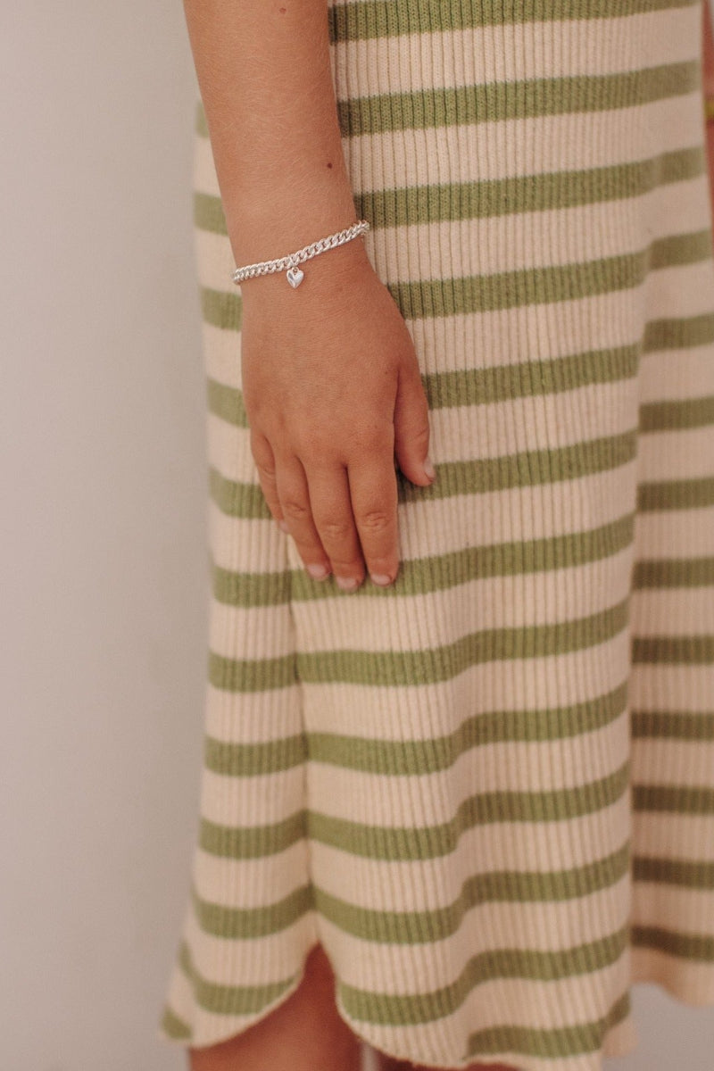 Lux wears a child length sterling silver Sweetheart Cuban Link bracelet.  This bracelet is adjustable and also available in baby and adult lengths.