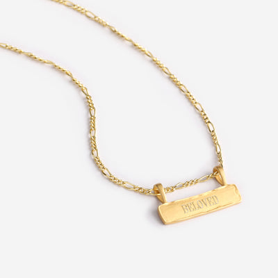 A Signature Bar Necklace with the word Beloved engraved on it.